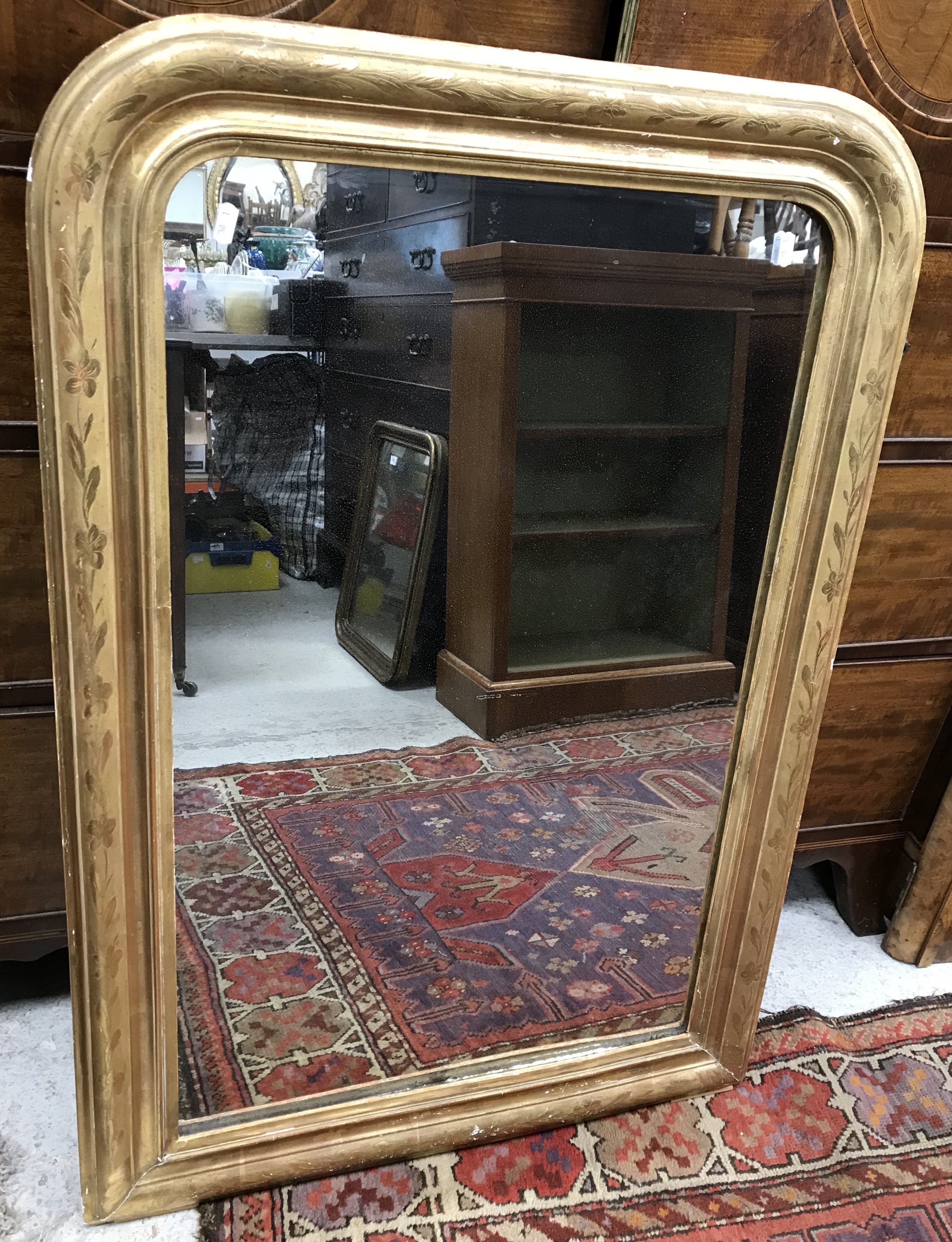 A circa 1900 carved giltwood wall mirror,