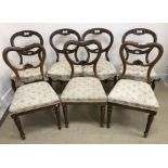 A set of four Victorian harebell carved shaped balloon back dining chairs on moulded cabriole legs