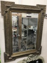 A 20th Century gilt framed rectangular wall mirror with wrigglework decoration enclosing a bevel