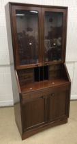 A mid to late 20th Century Danish mahogany secretaire bookcase in the manner of H W Klein for