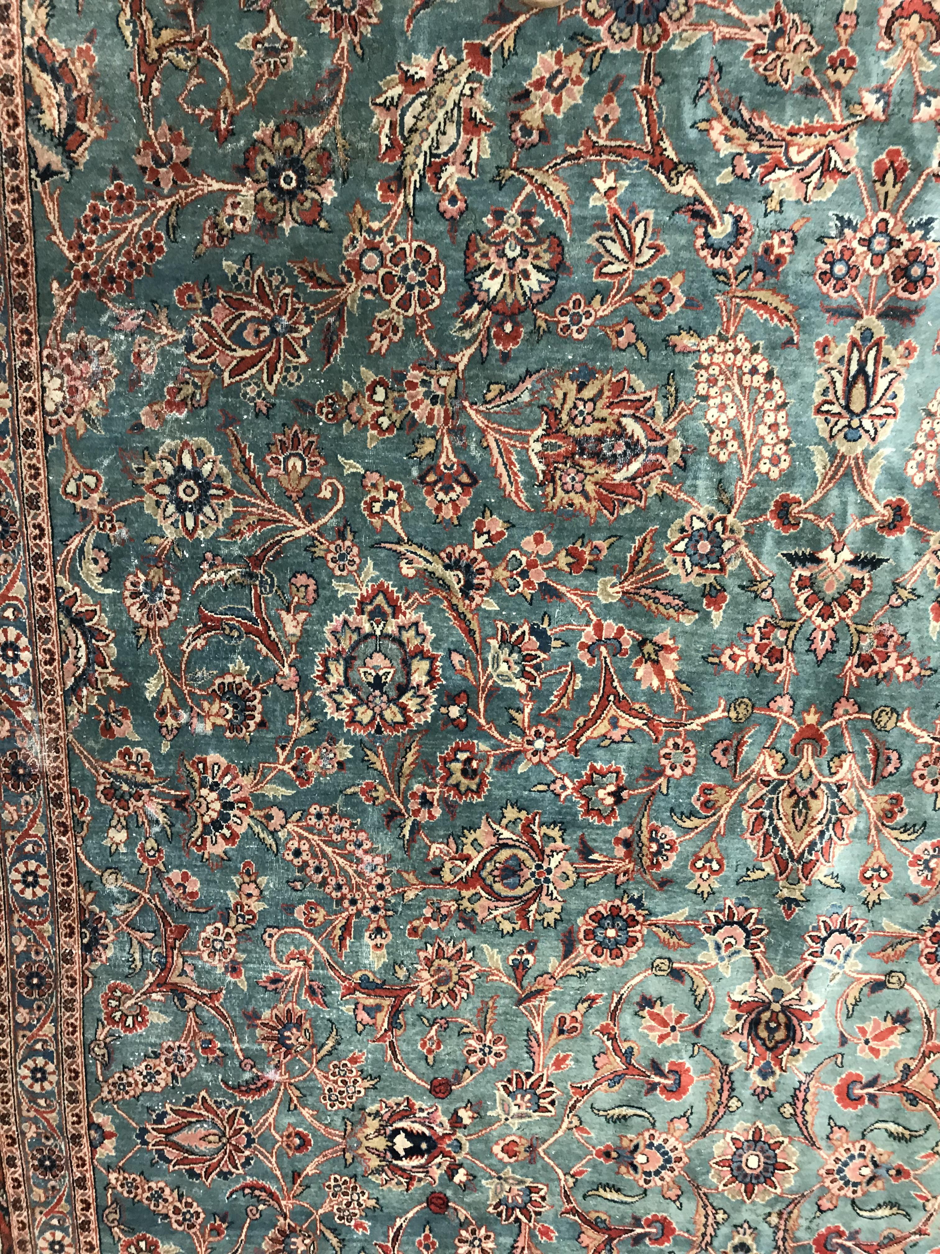 A Persian carpet, the central panel set with all-over scrolling foliate design on a teal ground, - Image 7 of 41