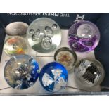 A collection of eight various 20th Century glass paperweights,