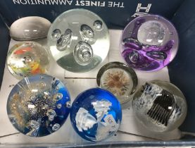 A collection of eight various 20th Century glass paperweights,