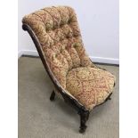 A Victorian rosewood framed buttoned scroll back salon chair on moulded cabriole legs to scroll