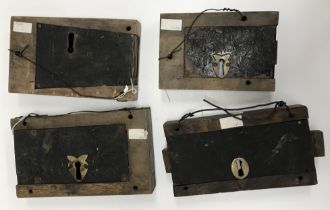 A collection of four various 19th Century wooden mounted iron door locks, largest 28 cm x 16 cm x 4.
