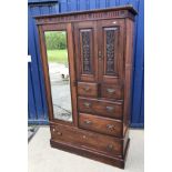 A late Victorian mahogany wardrobe compactum with single bevel edged mirror door and two carved