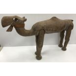 A carved treenware figure of a dromedary camel with basic articulated legs and jaw 51 cm high x 83