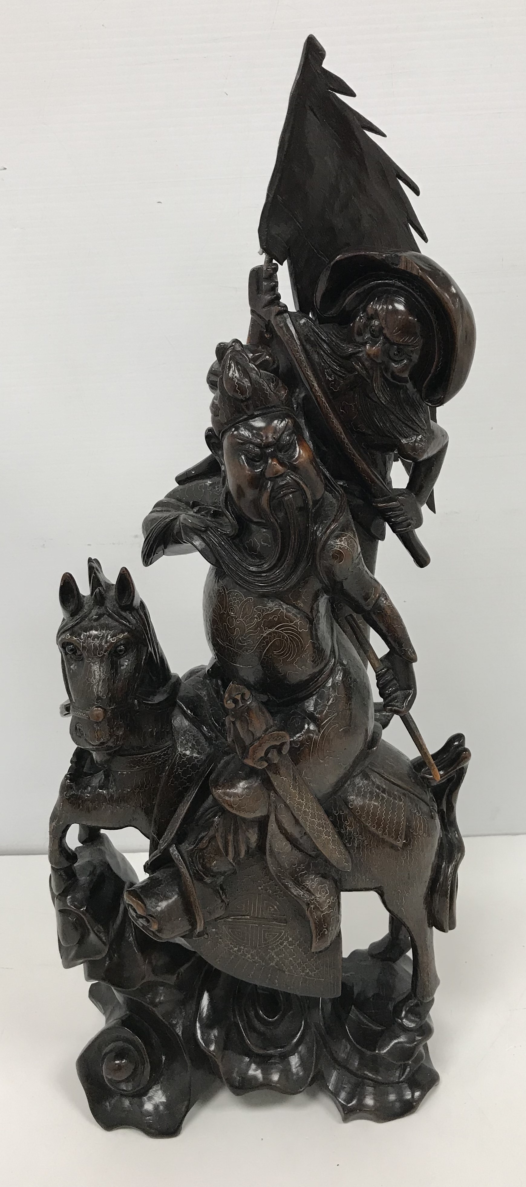A circa 1900 Chinese carved wood and silver wire inlaid figure group of a horse mounted warrior and