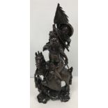 A circa 1900 Chinese carved wood and silver wire inlaid figure group of a horse mounted warrior and