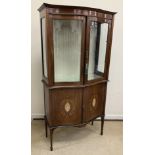 An Edwardian Sheraton Revival mahogany and inlaid serpentine fronted display cabinet,