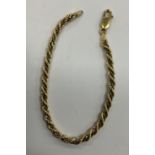 An 18 carat gold white and yellow rope twist bracelet, 19.8 cm long, 8.