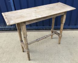 A 19th Century pine slim side table on turned legs united by stretchers,