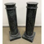 A pair of 19th Century variegated green marble columns or urn stands of plain ringed form,