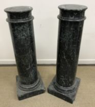 A pair of 19th Century variegated green marble columns or urn stands of plain ringed form,