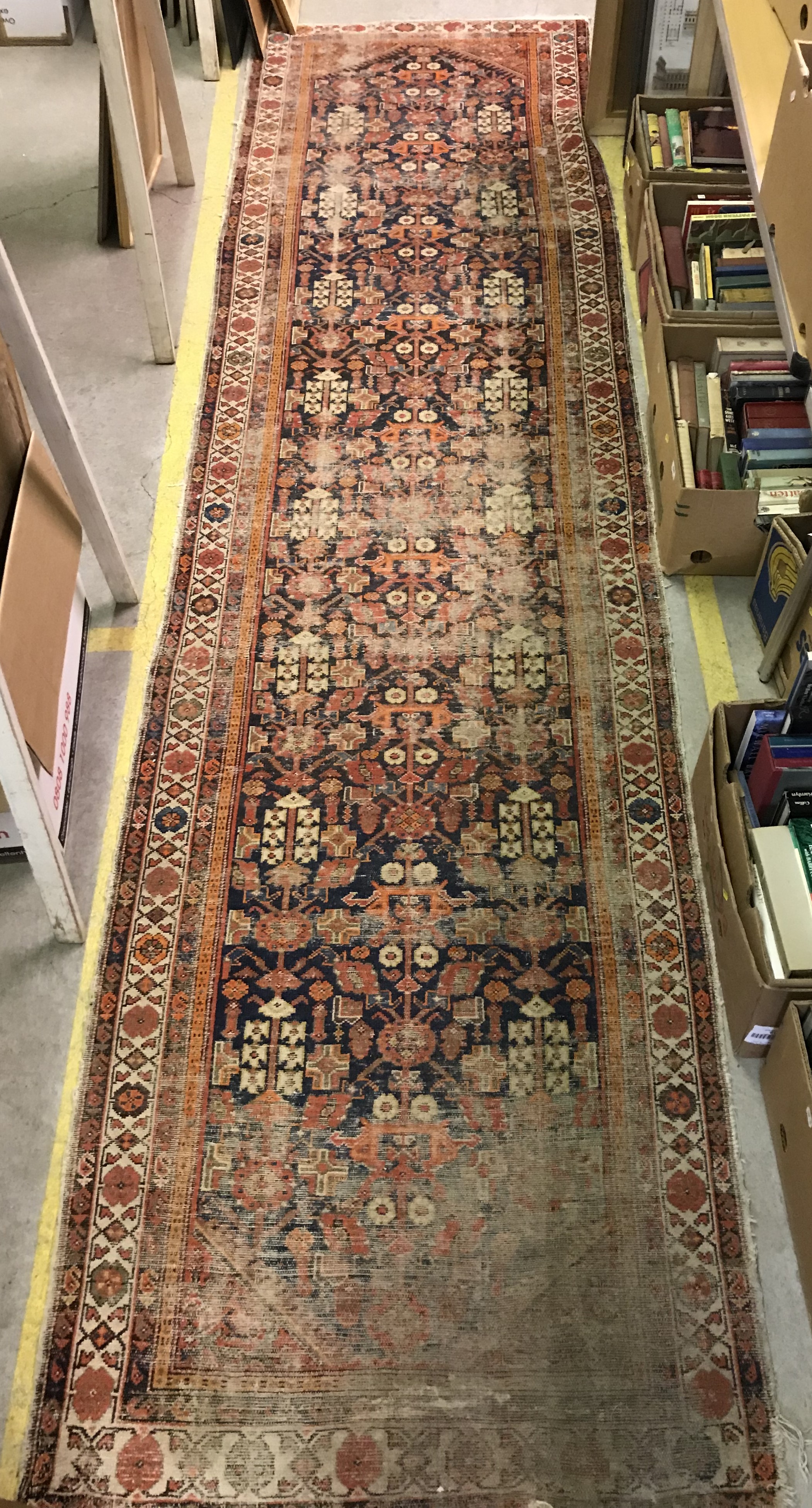 A Caucasian runner, the central panel set with all-over repeating design on a dark blue ground,