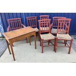 A set of six mid 20th Century red painted wrigglework decorated framed dining chairs,