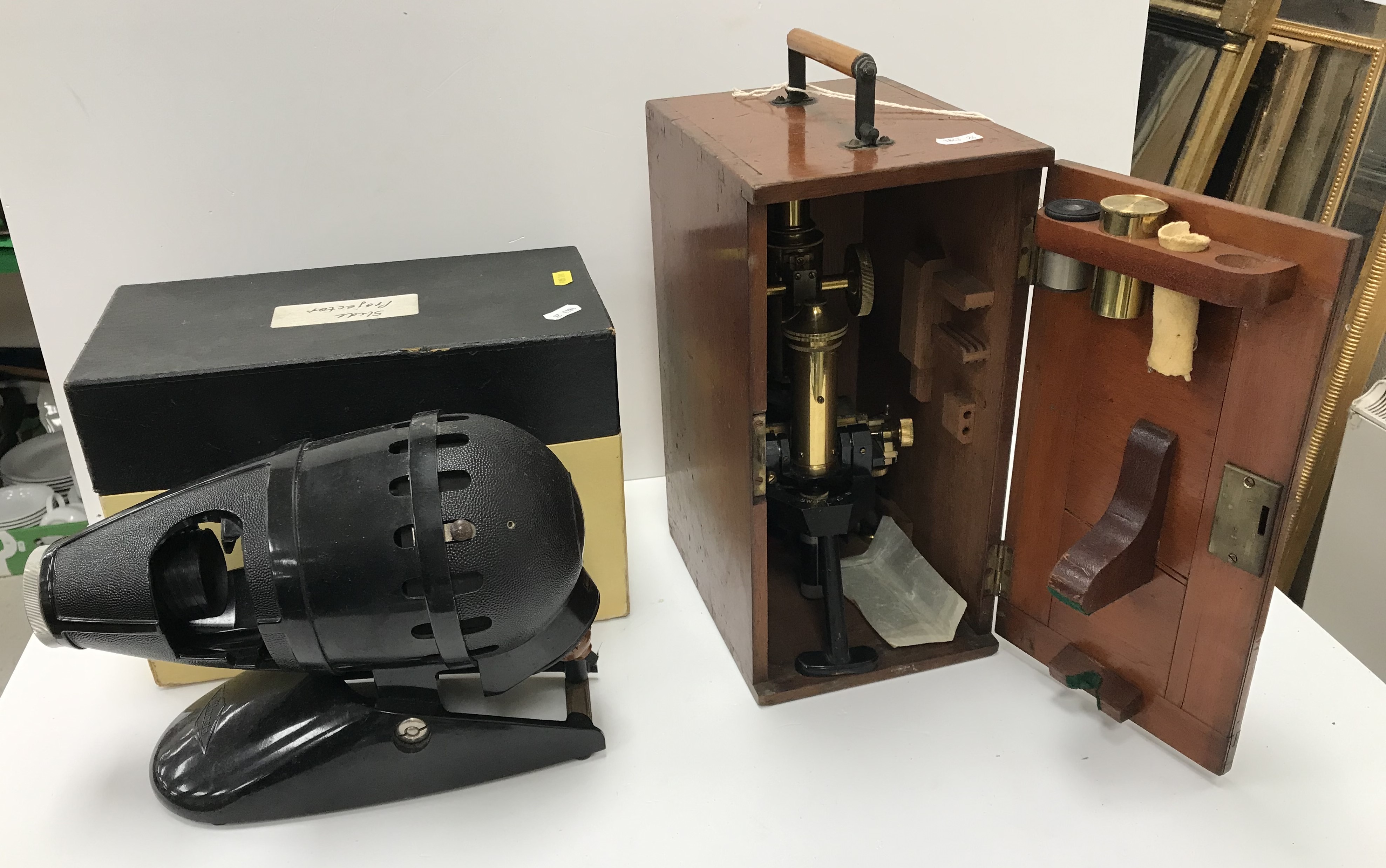 An early 20th Century Swift & Son of London brass and anodised cased monocular microscope and