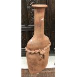 A modern terracotta bottle of large proportions with rope detail 90 cm high