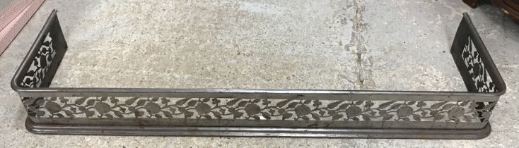 A 19th Century steel fire kerb with pierced decoration of thistles and roses emblematic of the