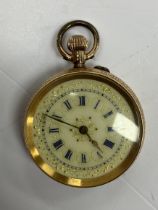 A late Victorian 14 carat gold ladies fob watch with gilt decorated porcelain dial and Roman