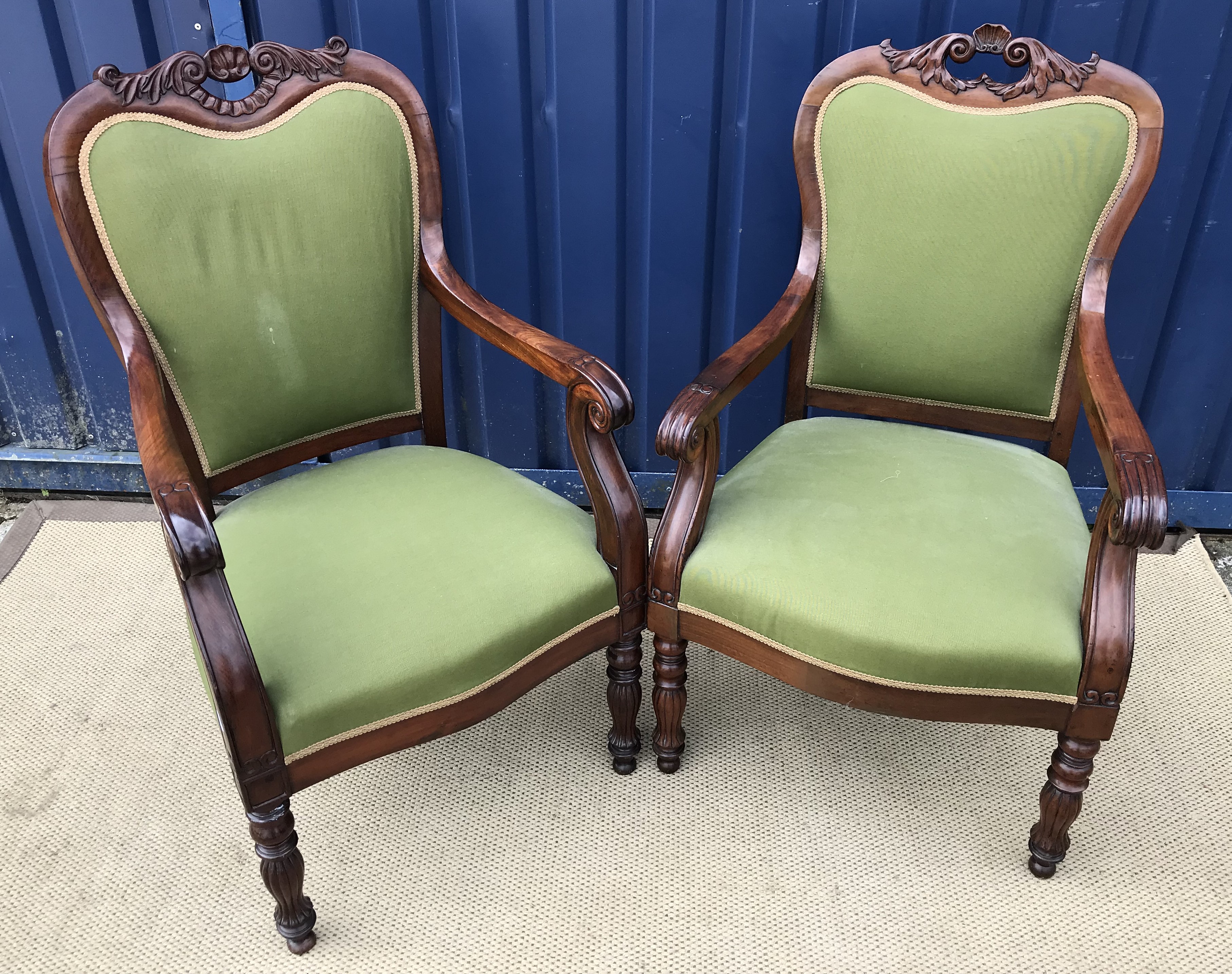Two near-matching mahogany framed salon armchairs in the Continental Rococo taste with foliate