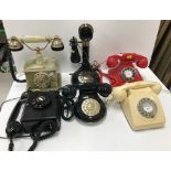 A vintage black bakelite cased wall mounted telephone, a red plastic cased "Carrington" telephone,