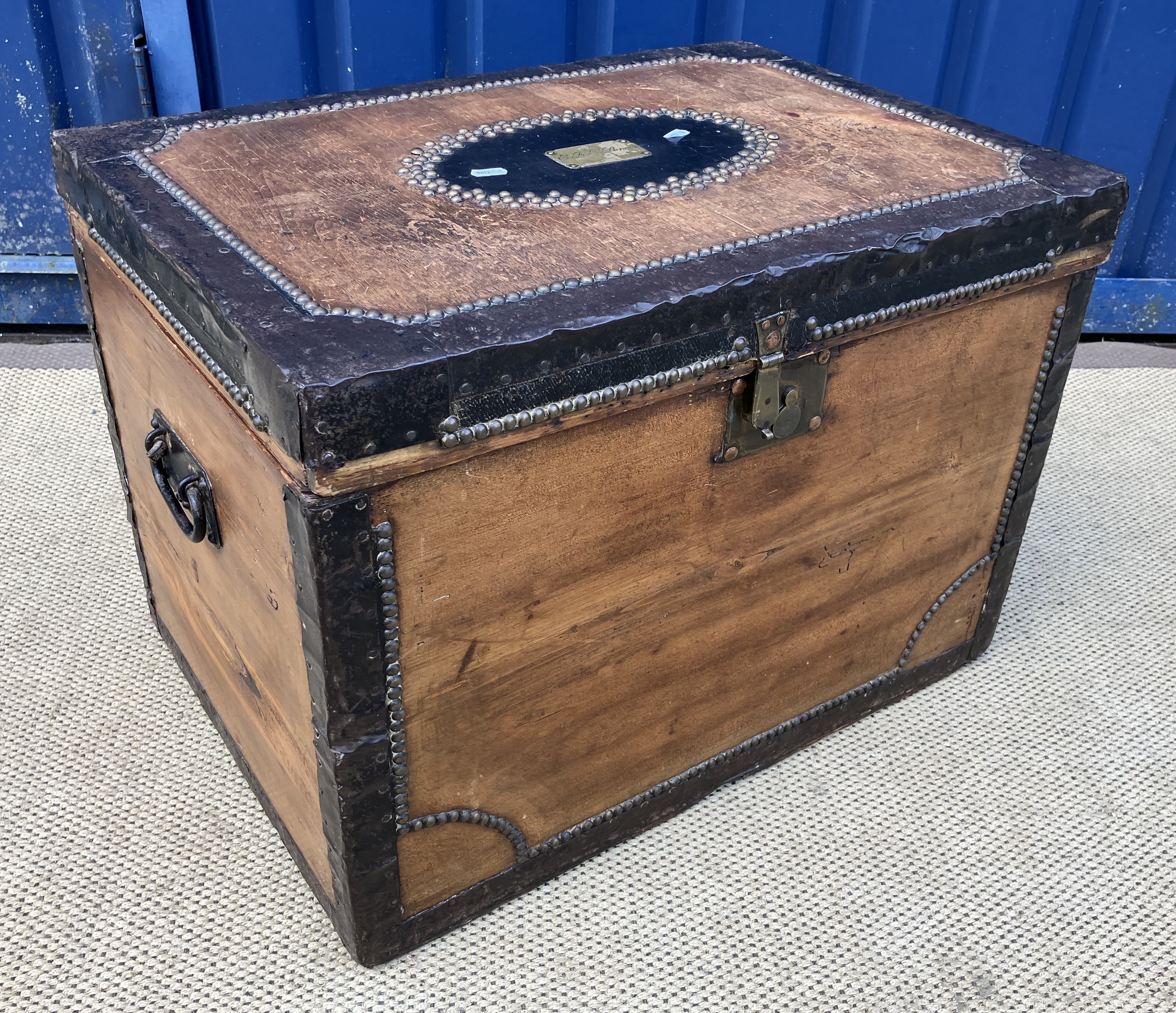 A 19th Century pine hinge lidded box with metal binding and brass studs,