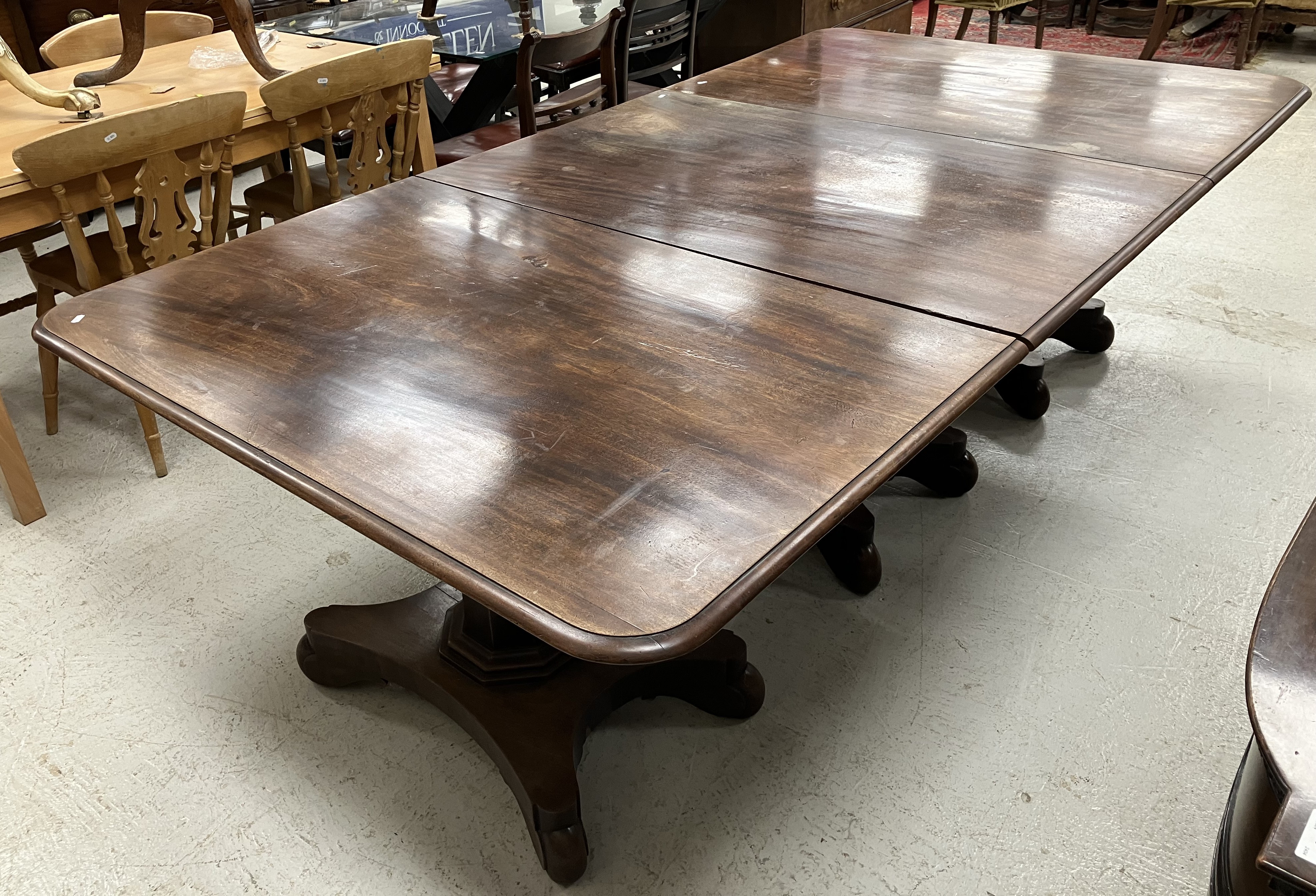 A 19th Century mahogany triple pillar dining table,