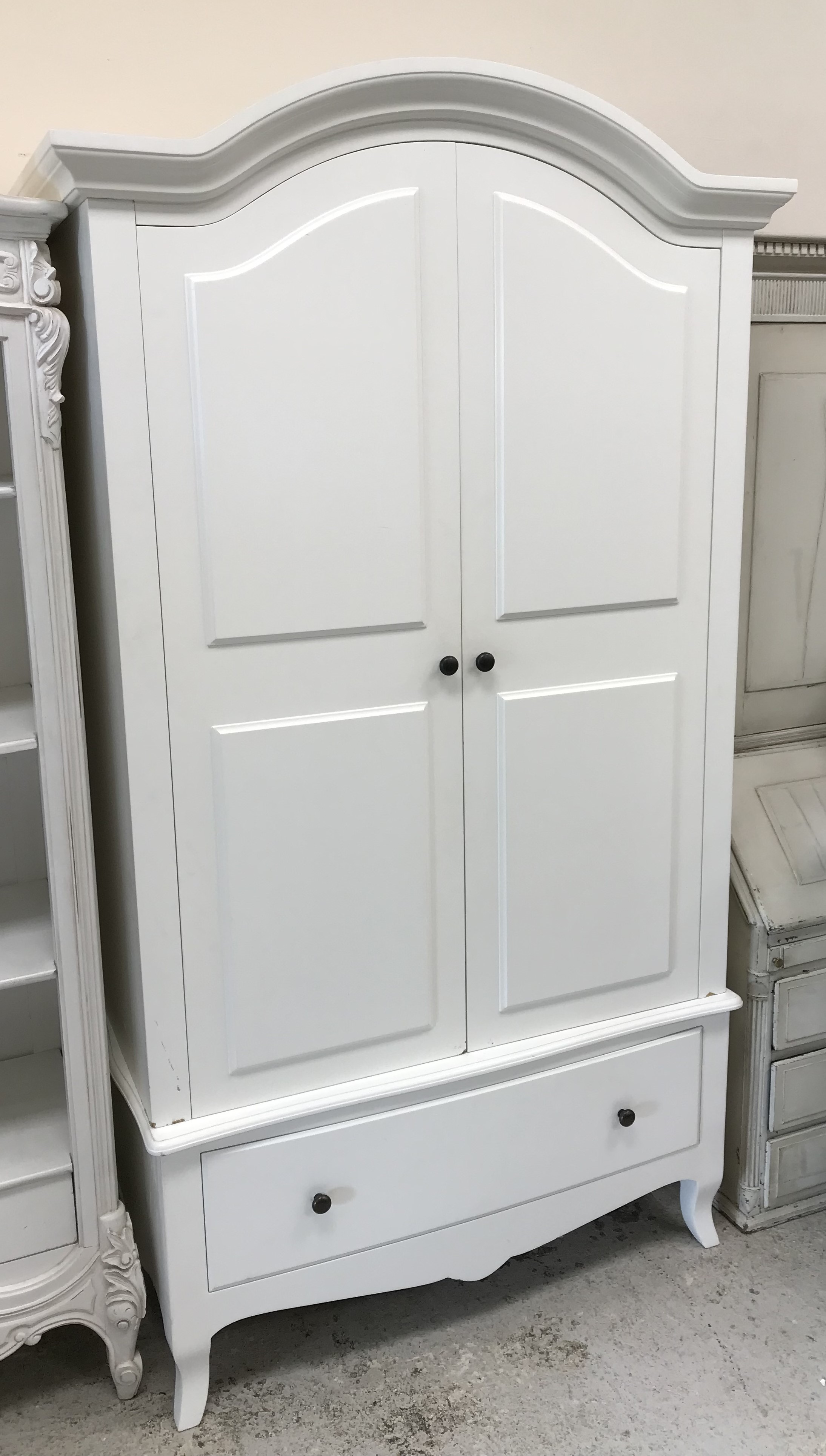 A modern white painted two door wardrobe with single drawer,