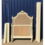 A duck egg blue and cream painted caned single bedstead in the French taste by And So To Bed with