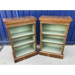 A pair of walnut open bookcases in the 19th Century manner,