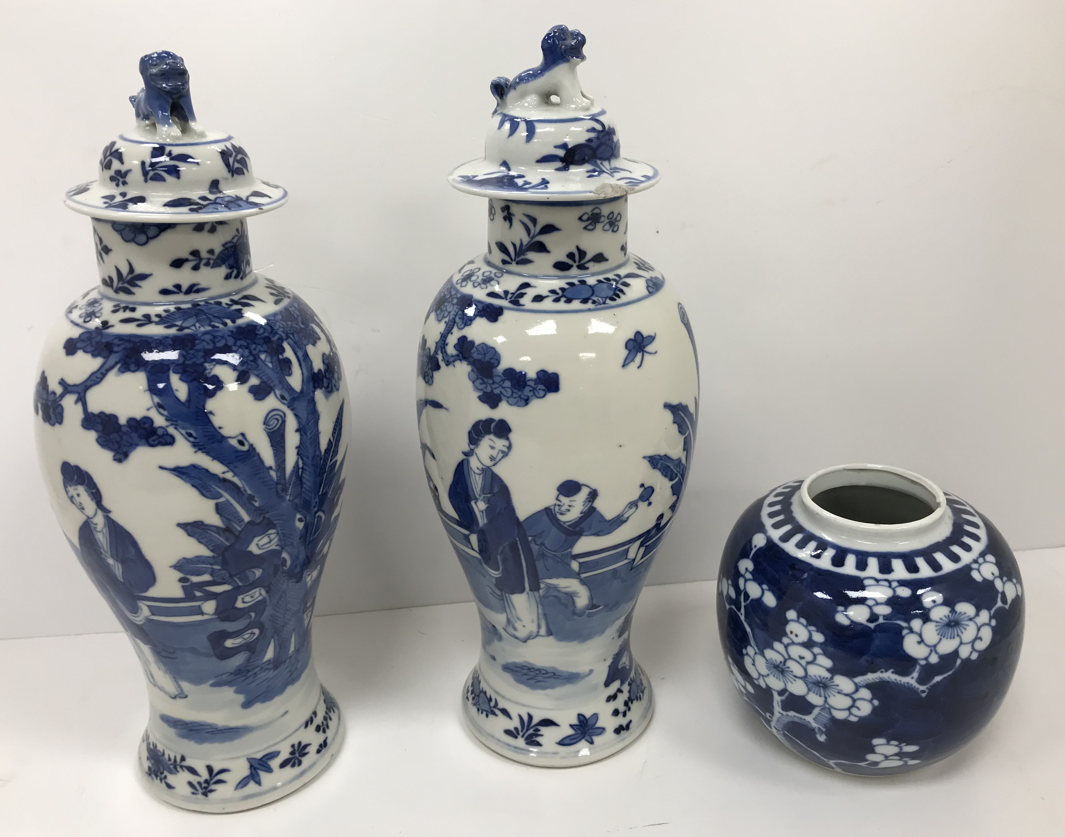 A pair of 19th Century Chinese blue and white baluster shaped vases and covers,