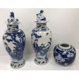 A pair of 19th Century Chinese blue and white baluster shaped vases and covers,