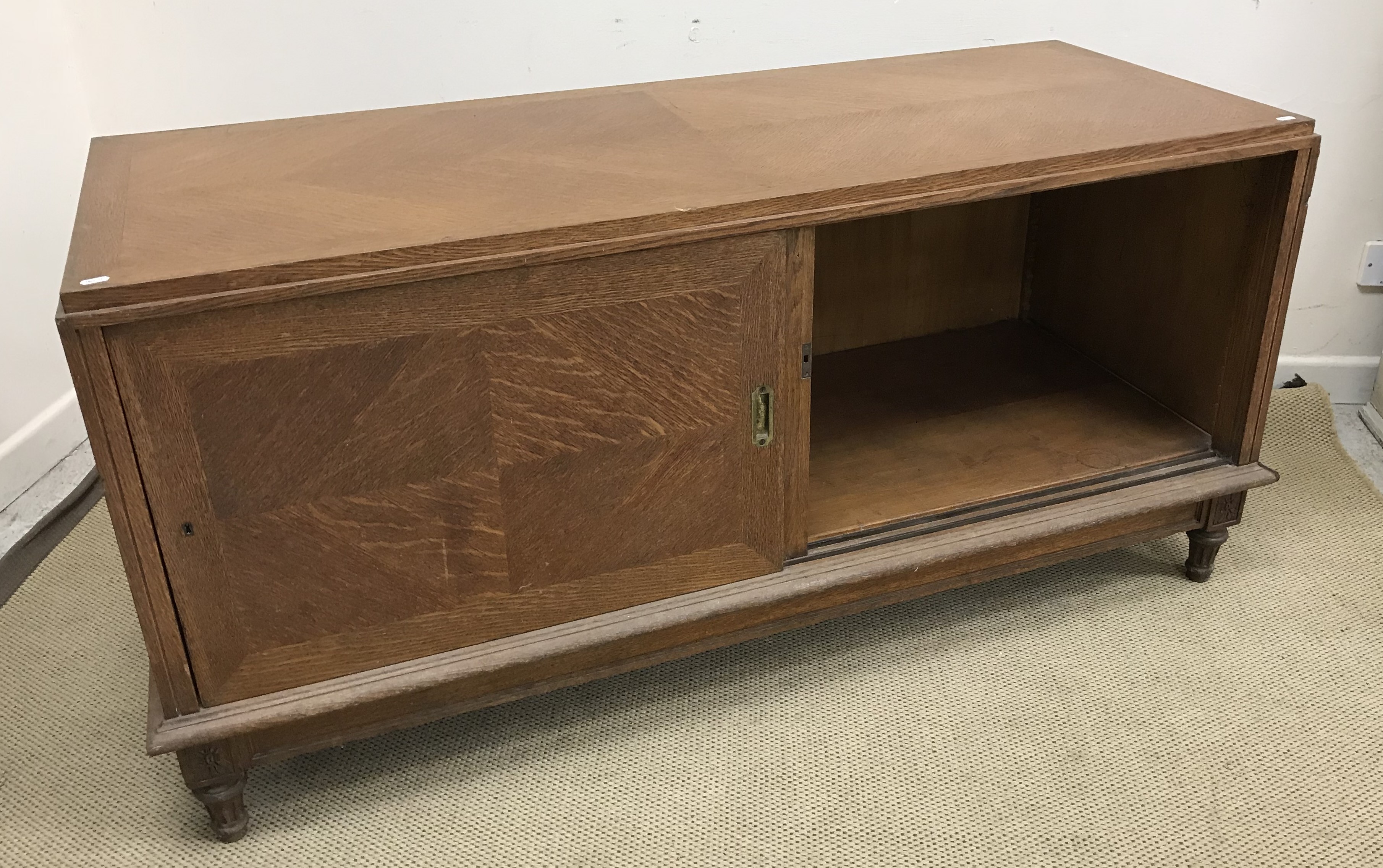 A mid 20th Century oak side cabinet formerly from a French haberdashery,