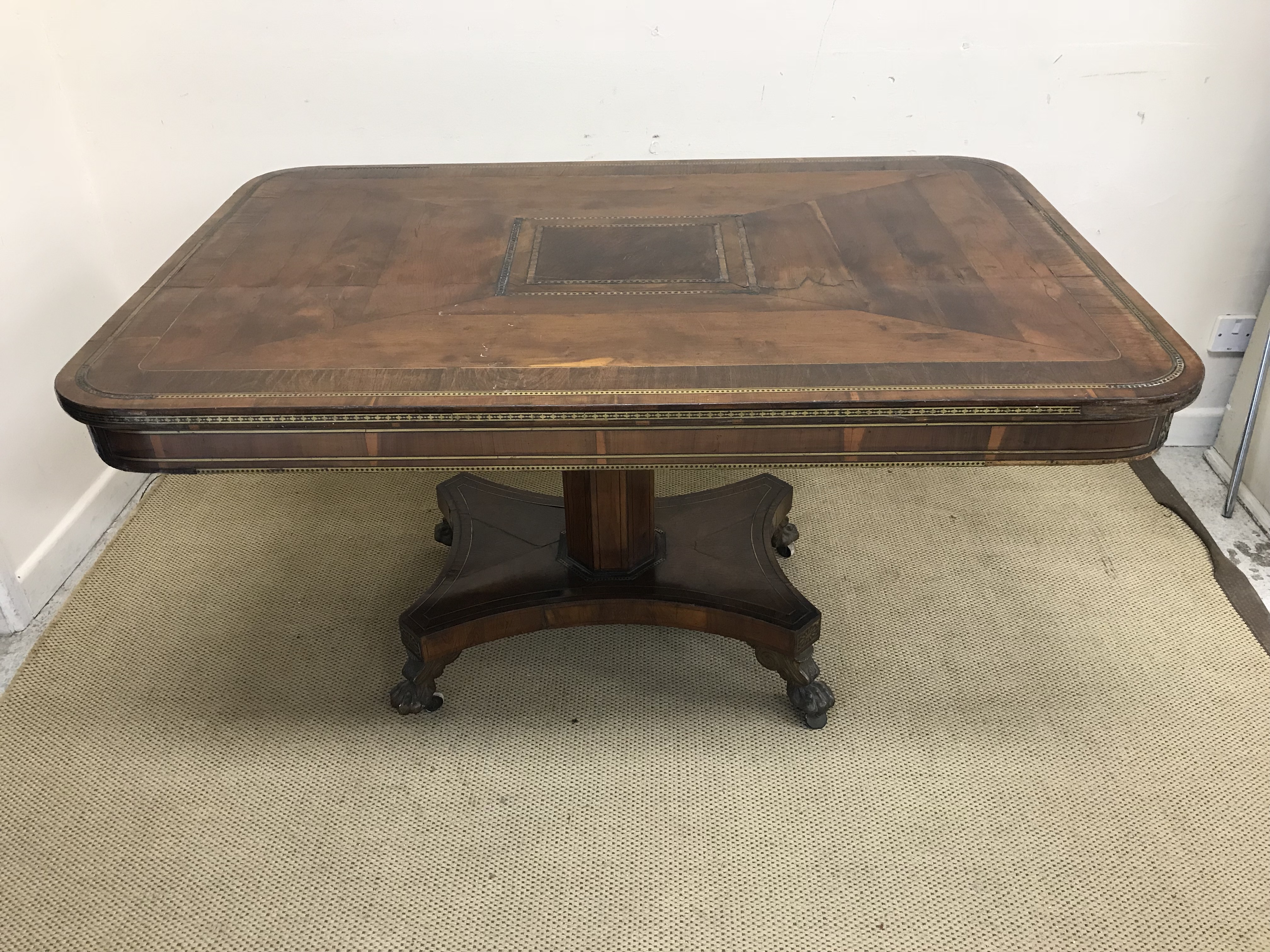 A Regency yew wood rosewood cross banded and brass inlaid breakfast table,
