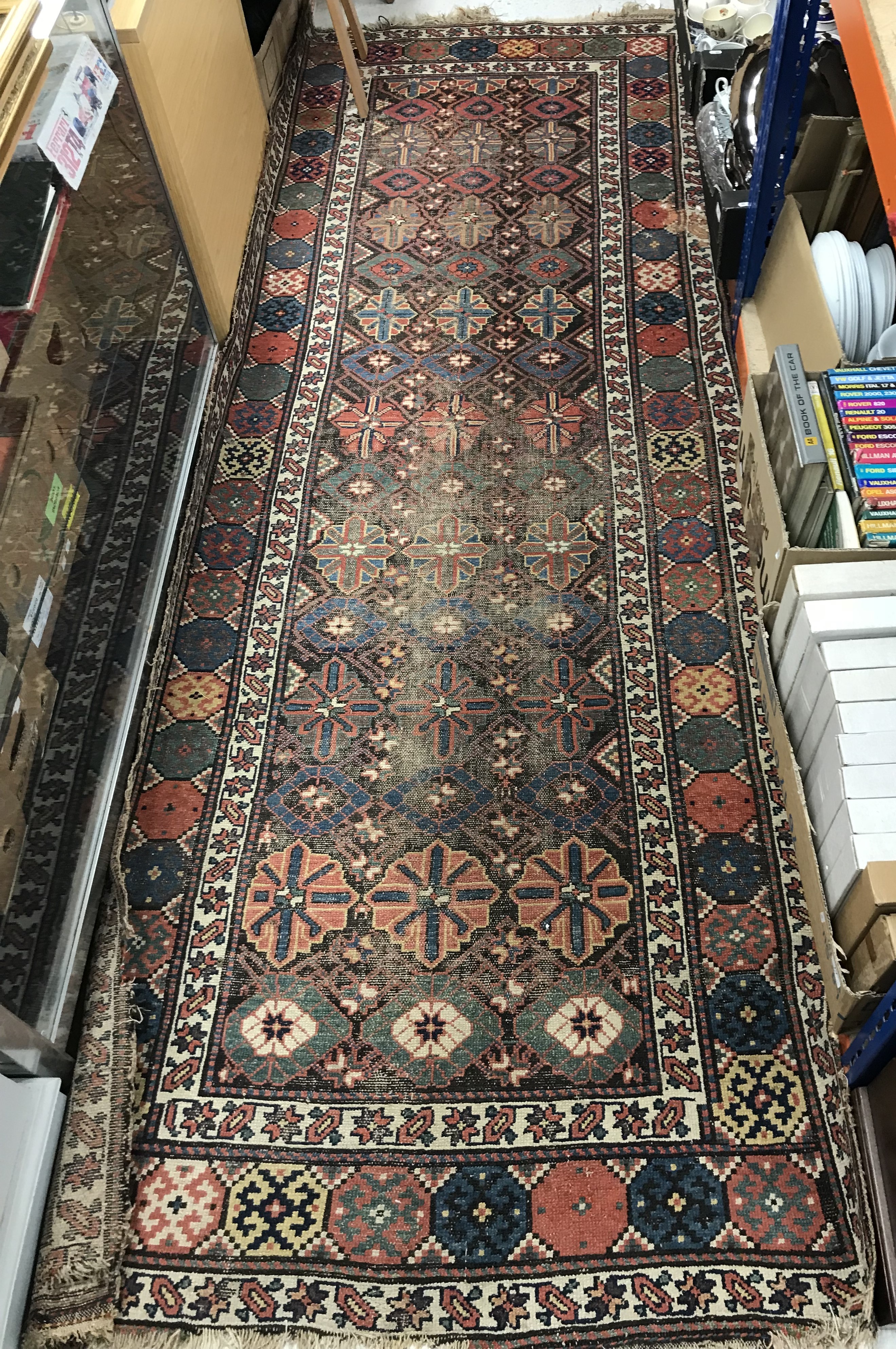 A Persian runner, the central panel set with repeating decoration on a brown ground,