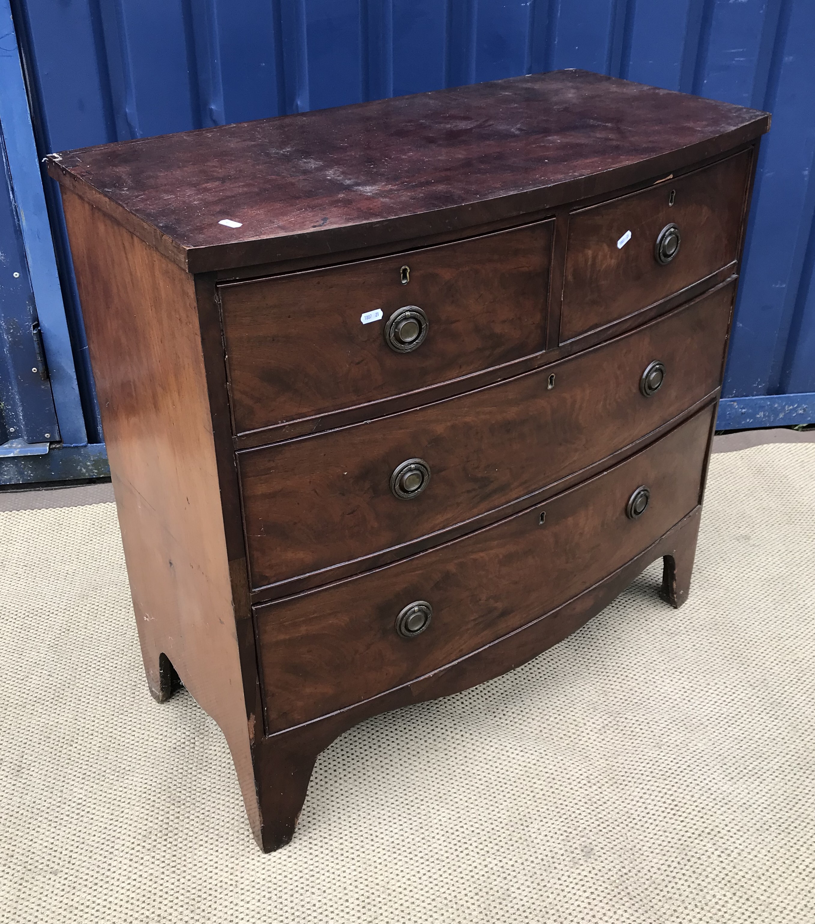 An early 19th Century mahogany bow fronted chest of two short over two long drawers on bracket feet,