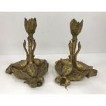 A pair of 19th Century gilt bronze candlesticks as three swans with foliate decorated candle holder