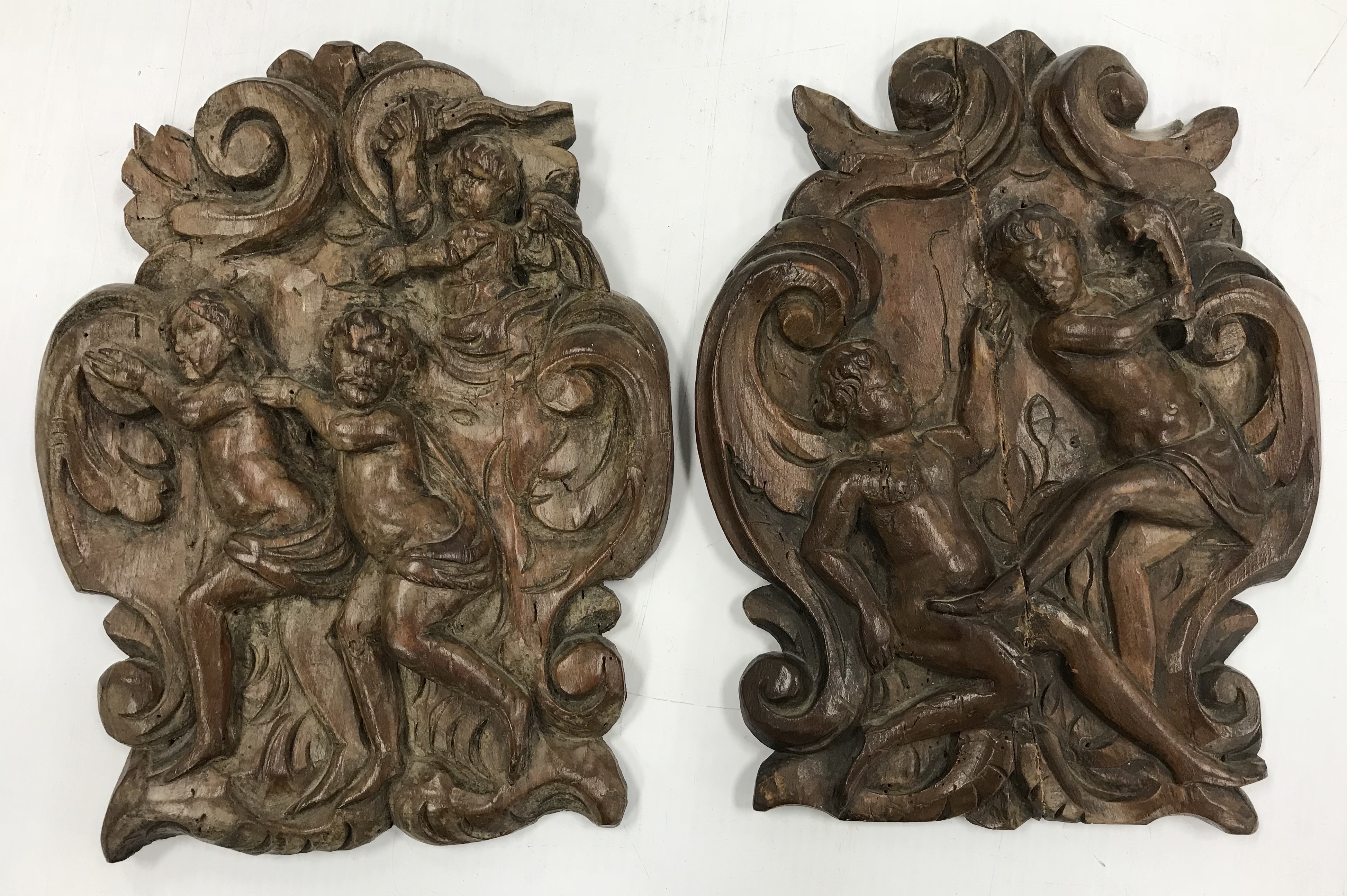 A Continental carved walnut panel depicting "The expulsion of Adam and Eve from the Garden of Eden