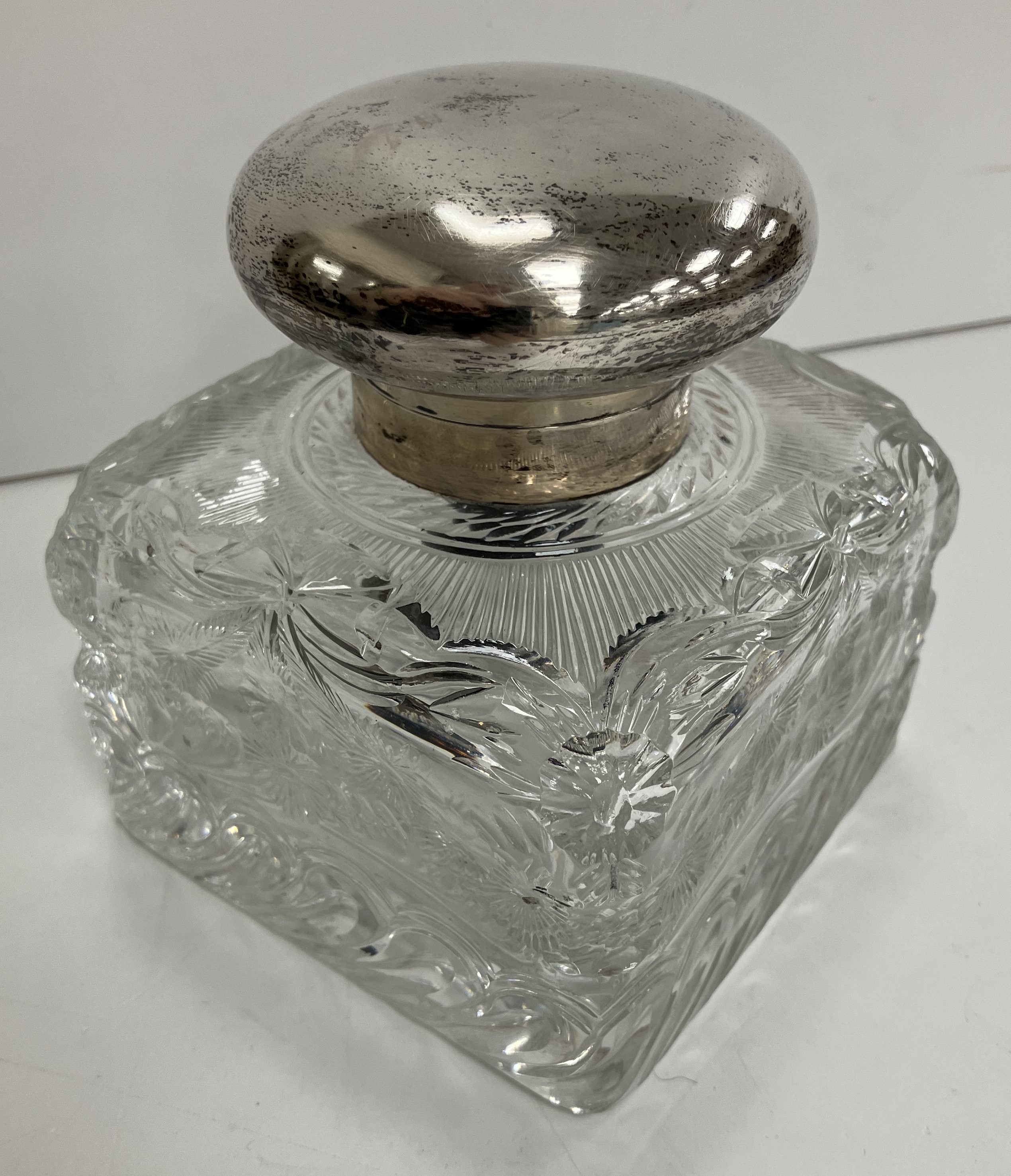 A George V heavy cut glass inkwell of square form with silver mounts (maker's mark obscured .....