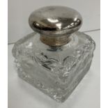 A George V heavy cut glass inkwell of square form with silver mounts (maker's mark obscured .....