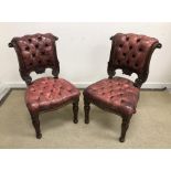 A pair of Victorian mahogany framed and red studded leather upholstered dining chairs,