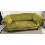 A Victorian Chesterfield sofa in modern lime green corduroy upholstery raised on ringed and turned