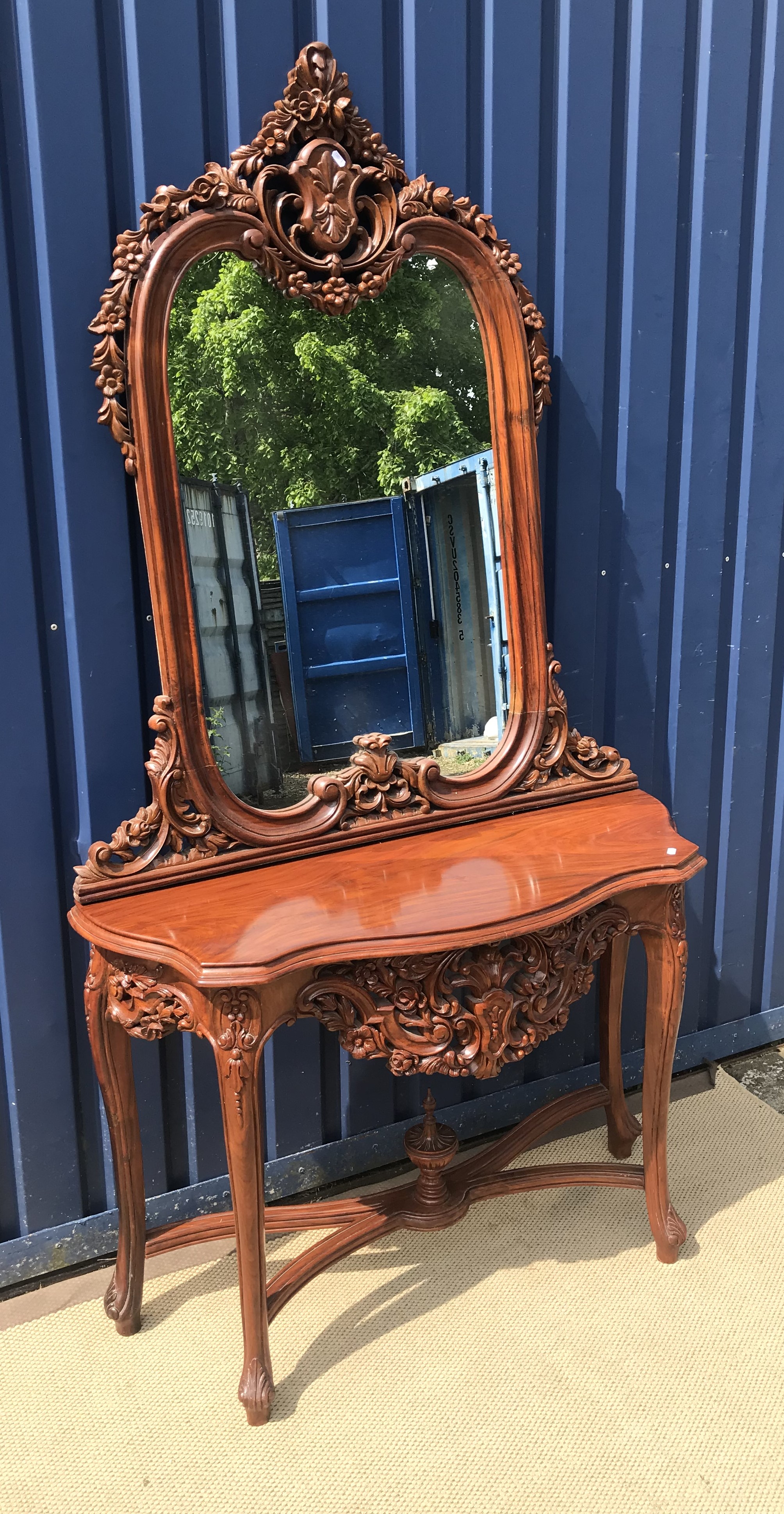 A modern mahogany console table profusely decorated scrolling foliate frieze to cabriole legs