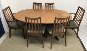 A G Plan teak D end dining table on end pillar supports to curved feet united by a centre stretcher