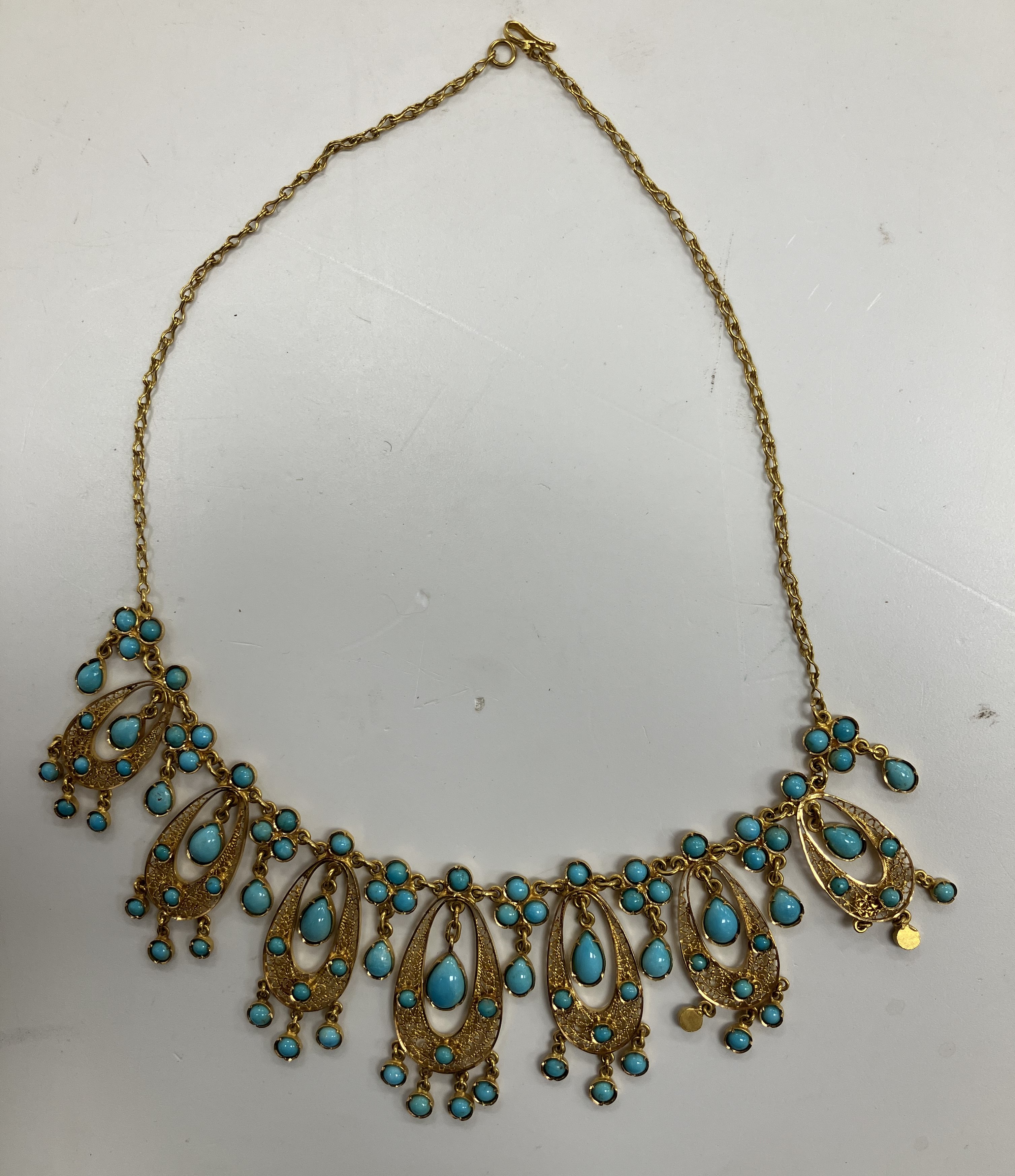 A modern Iranian 18 carat gold and filigree work and turquoise bead set necklace with seven