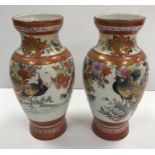 A pair of Japanese Meiji Period Kutani Sei vases decorated with pea fowl amongst flowers and