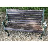 A green wooden slatted garden bench,