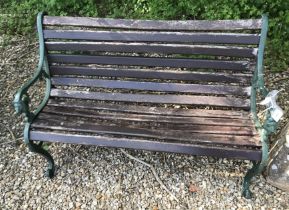 A green wooden slatted garden bench,