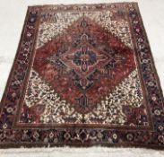 A Persian Heriz carpet, the central pane
